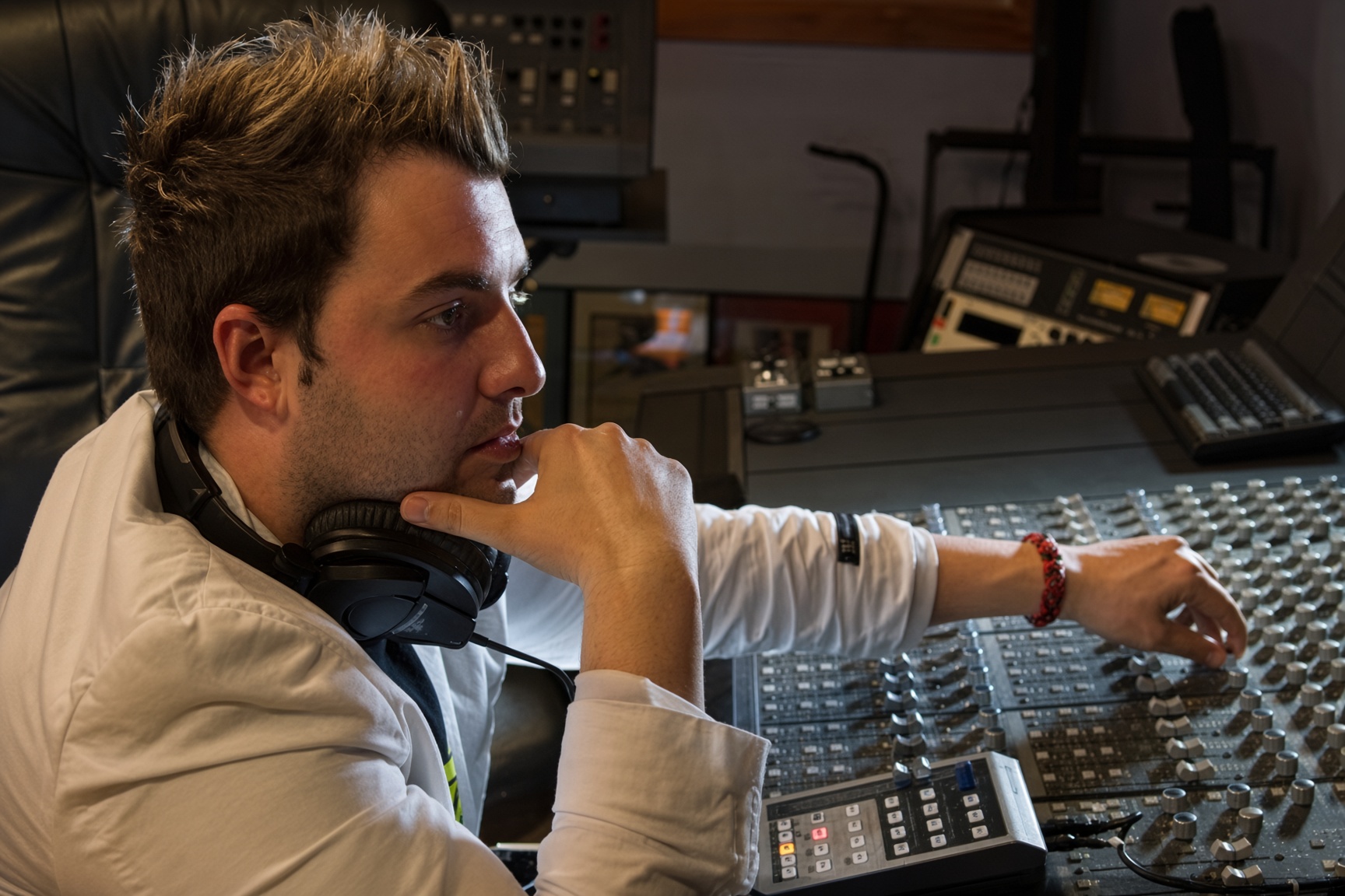 Juan Mario at the mixing console with headphones around his neck